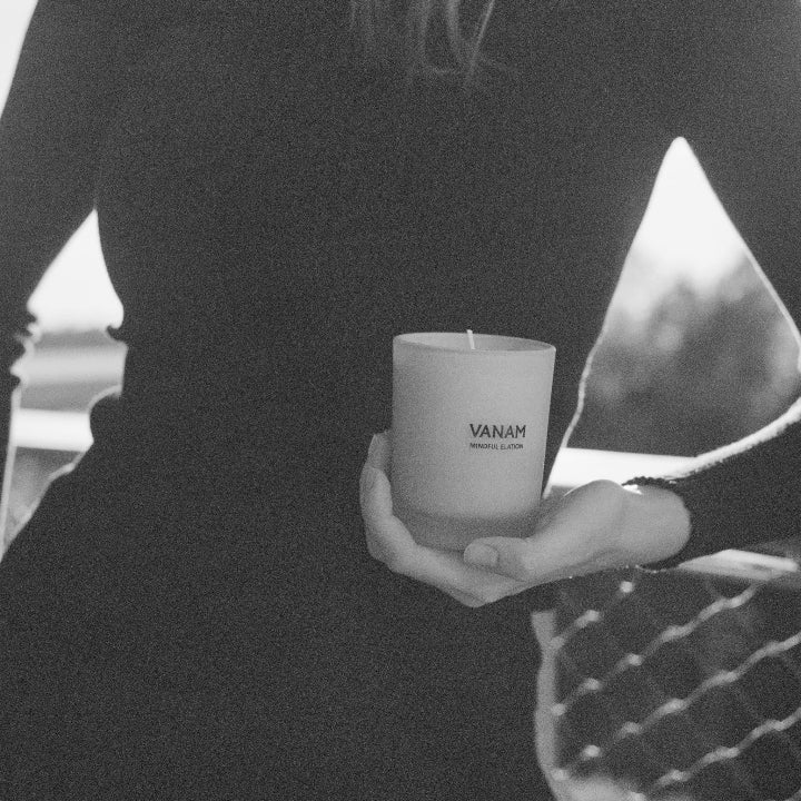 Person holding a Vanam MINDFUL ELATION beeswax candle —  clean, luxury scented candle